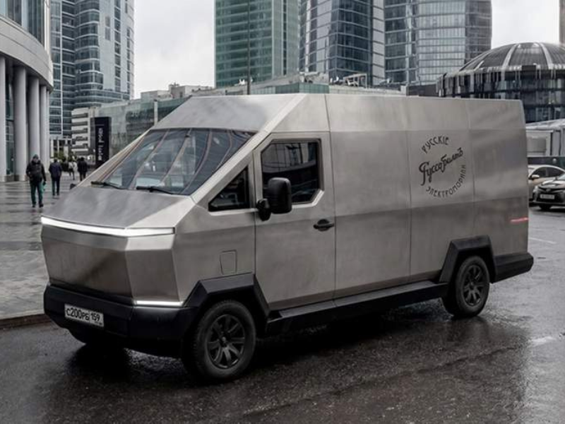 روسو بالت F200 فان كهربائية بتصميم مستقبلي مستوحى من تسلا سايبرتراك وواجهة فولاذية حادة التصميم الجانبي لروسو بالت F200 مع هيكل من الفولاذ المقاوم للصدأ وخطوط هندسية حادة الخلفية الصندوقية لروسو بالت F200 مع مصابيح LED ممتدة بعرض السيارة روسو بالت F200 الكهربائية أثناء القيادة تُظهر الحجم الضخم والهيكل المتين مقصورة روسو بالت F200 مع شاشة لمس 14 إنش وتصميم عملي مخصص للاستخدام الشاق تفاصيل هيكل روسو بالت F200 المصنوع من الفولاذ المقاوم للصدأ بضمان 100 عام عجلات روسو بالت F200 مع تعليق هوائي خلفي مخصص للطرق الوعرة نظام كاميرات 360 درجة في روسو بالت F200 الكهربائية لتعزيز السلامة والرؤية منفذ الشحن السريع الأمامي في فان روسو بالت F200 الكهربائية روسو بالت F200 Russo-Balt F200 فان كهربائية شاحنة كهربائية روسية سيارة تشبه سايبرتراك سيارات كهربائية 2027 The Russo-Balt F200 is an electric van with a futuristic design inspired by the Tesla Cybertruck and a sharp steel front fascia. The Russo-Balt F200's side profile features a stainless steel body and sharp geometric lines. The Russo-Balt F200's boxy rear features LED taillights spanning the width of the vehicle. Driving the Russo-Balt F200 showcases its imposing size and robust build. The Russo-Balt F200's interior boasts a 14-inch touchscreen and a practical design built for heavy-duty use. Details of the Russo-Balt F200's stainless steel body, backed by a 100-year warranty. The Russo-Balt F200's wheels feature a rear air suspension system designed for off-road driving. The Russo-Balt F200 is equipped with a 360-degree camera system for enhanced safety and visibility. The Russo-Balt F200 features a front-mounted fast-charging port. Russo-Balt F200 Russo-Balt F200 Electric Van Russian Electric Van Cybertruck-like Vehicle Electric Vehicles 2027