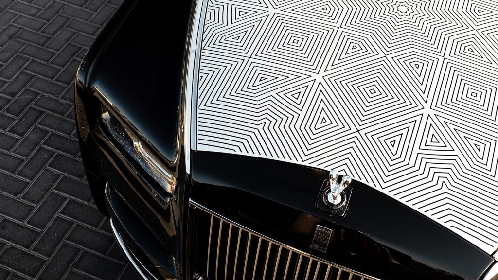 رولز رويس فانتوم أرابيسك

Rolls Royce Phantom Arabesque

سيارات رولز رويس الشرق الأوسط

رولز رويس بيسبوك

سيارات فاخرة حصرية

luxury bespoke Rolls Royce

laser engraved hood Rolls Royce

Middle East inspired luxury cars

Rolls Royce Phantom Middle East

ultra luxury bespoke cars

رولز-رويس فانتوم أرابيسك 2026 بغطاء محرّك منقوش بالليزر مستوحى من المشربية

Rolls-Royce Phantom Arabesque 2026 laser-engraved hood inspired by Mashrabiya design

تصميم خارجي ثنائي اللون لسيارة رولز-رويس فانتوم أرابيسك الفاخرة

Two-tone exterior design of Rolls-Royce Phantom Arabesque luxury sedan

تفاصيل شبكة بانثيون المضيئة وتمثال روح السعادة في فانتوم أرابيسك

Illuminated Pantheon grille and Spirit of Ecstasy on Rolls-Royce Phantom Arabesque

غاليري المقصورة مع تطعيمات خشبية مستوحاة من العمارة العربية

Bespoke dashboard gallery with Mashrabiya-inspired wood inlays inside Phantom Arabesque

مقصورة رولز-رويس فانتوم أرابيسك مع تطريزات هندسية مستوحاة من المشربية

Rolls-Royce Phantom Arabesque interior with Mashrabiya-inspired embroidery

تفاصيل نقش الليزر الحصري على غطاء المحرّك في رولز-رويس فانتوم أرابيسك

Close-up laser engraving detail on Rolls-Royce Phantom Arabesque hood